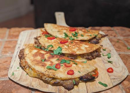 Korean Quesadillas on a wood serving platter.