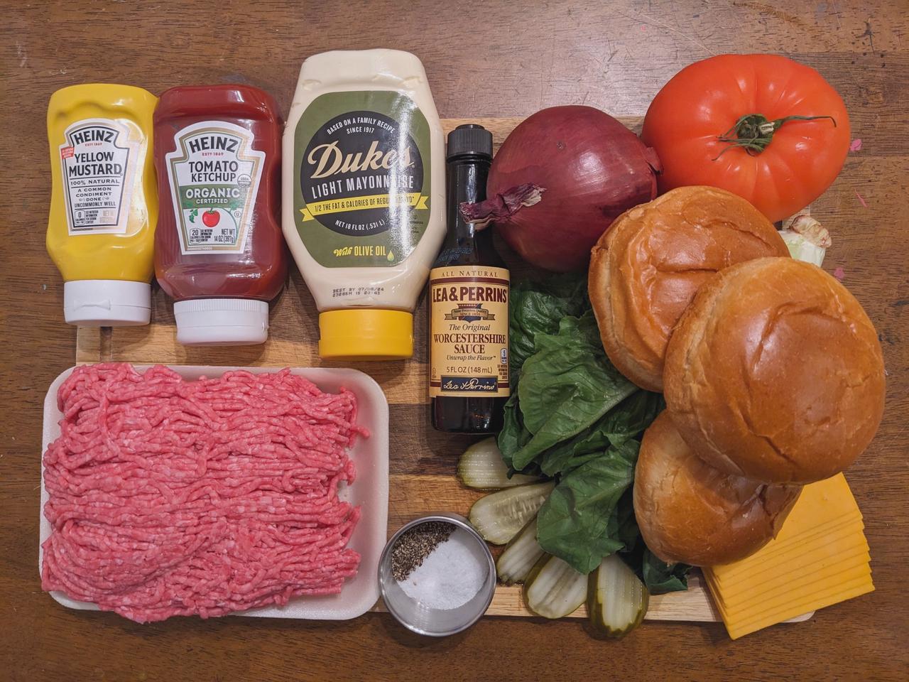 Platter of ingredients for a cheeseburger.