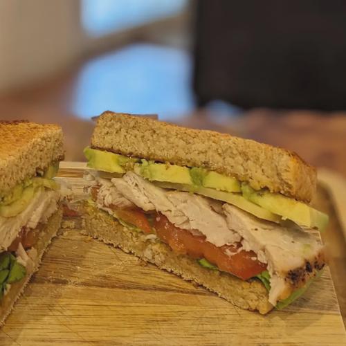 Cross-section of Grilled Chicken and Avocado Sandwich with Honey-Mustard Spread.