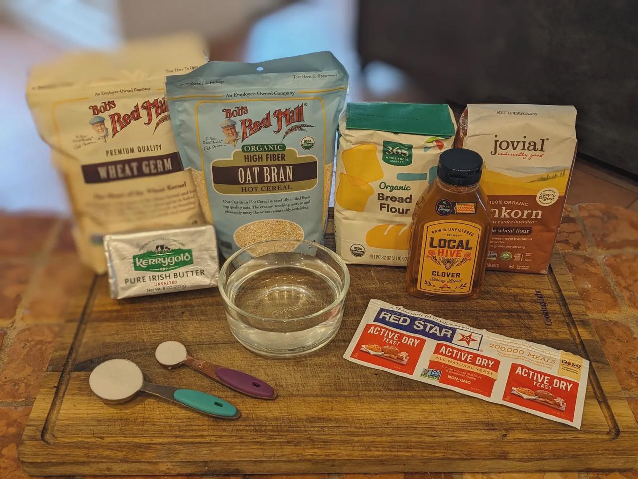 Platter of ingredients for high-fiber white bread on a cutting board.