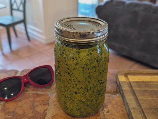 A jar of prepared green seasoning.