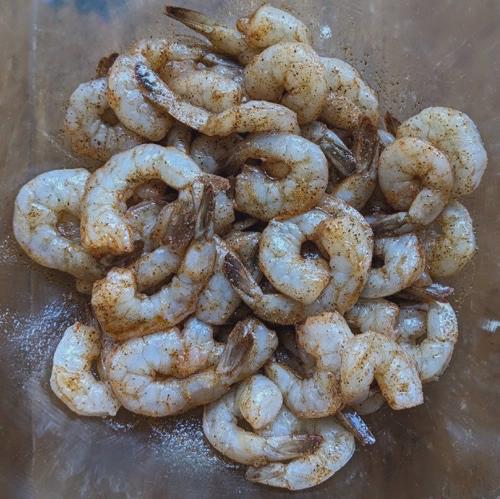 Shrimp marinating in a bowl.