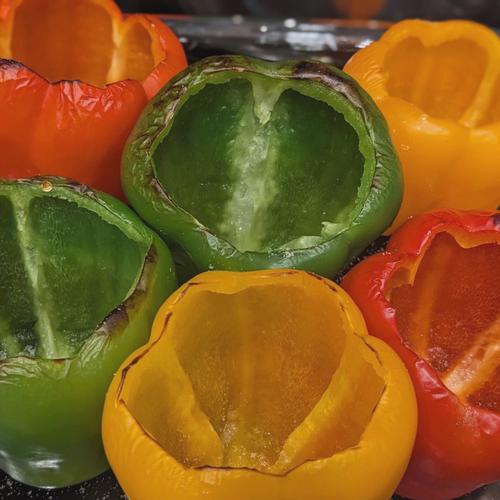 Charred bell peppers, showing the process of preparing the peppers for stuffing.