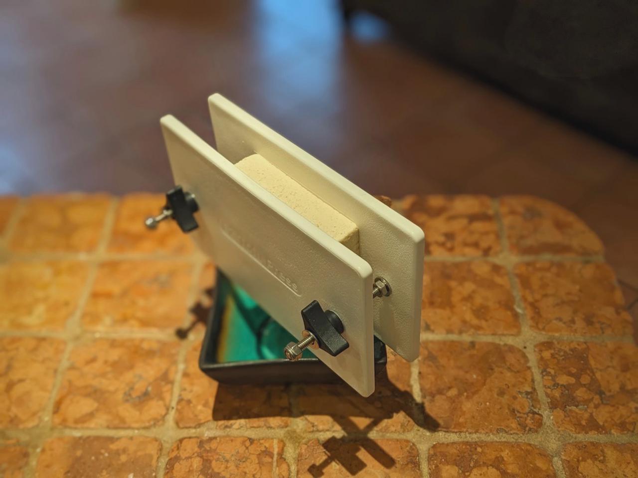 Simple tofu press made from plastic plates and screws.