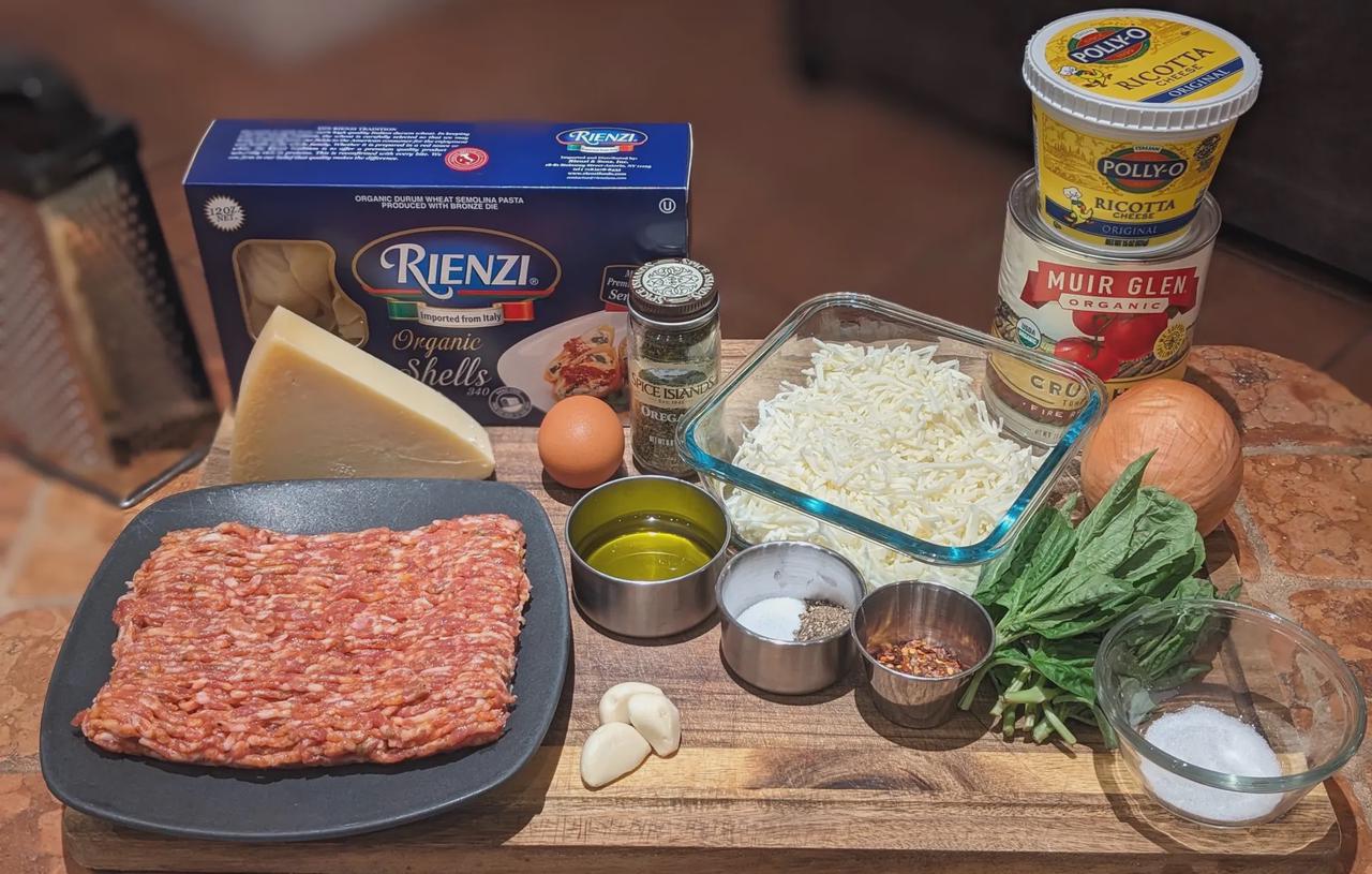 Platter of Spicy Sausage and Cheese Stuffed Shells ingredients on a cutting board.