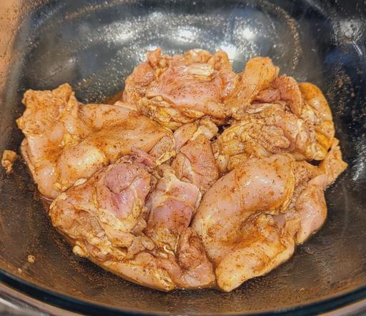 Marinating chicken in a bowl.